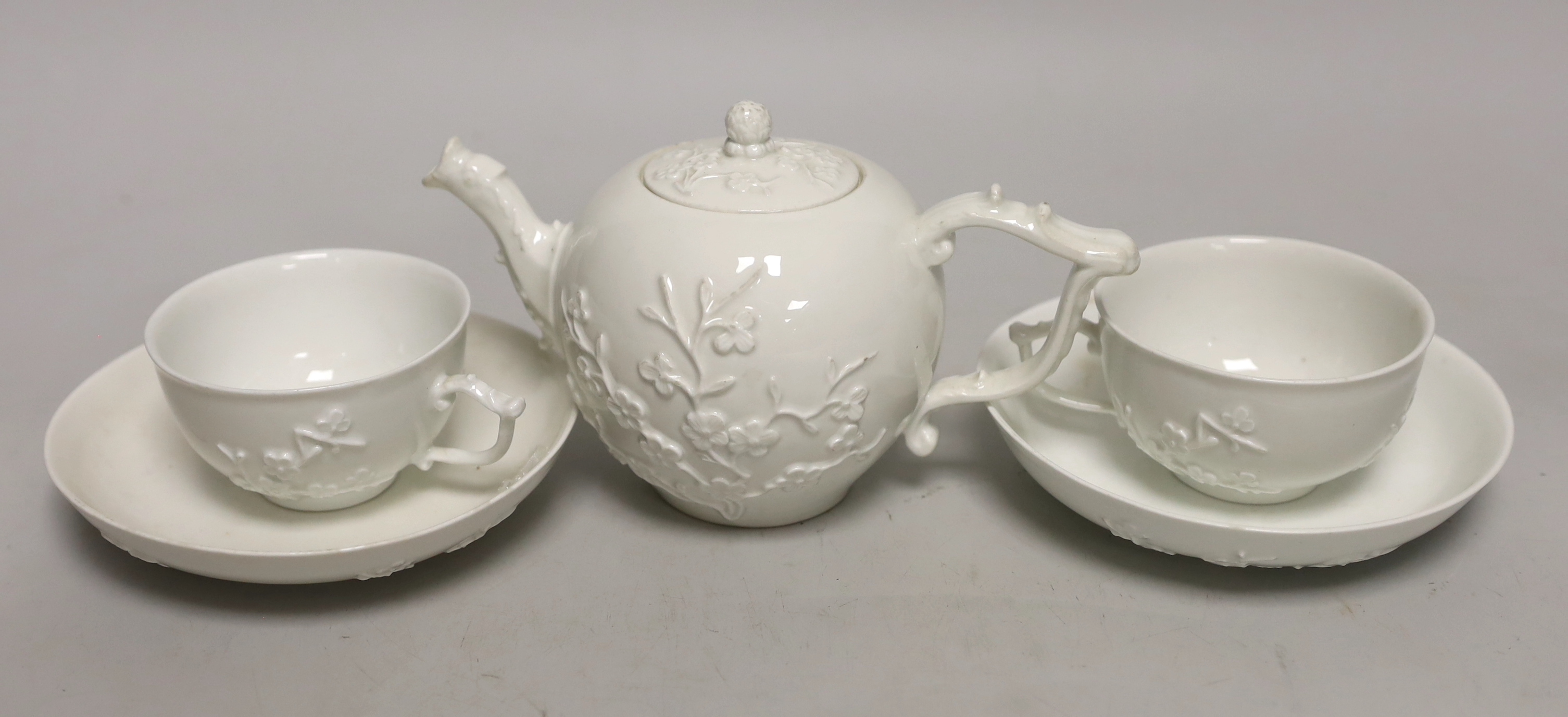 A 18th century Meissen teapot and two teacups and saucers, c.1740